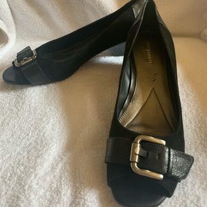 Wedge open toed black suede heels.